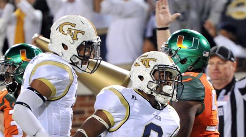 Georgia Tech A-back Tony Zenon, shown here celebrating his six-yard touchdown run against Miami, also contributed two third-down conversion plays against the Hurricanes. (HYOSUB SHIN/AJC)