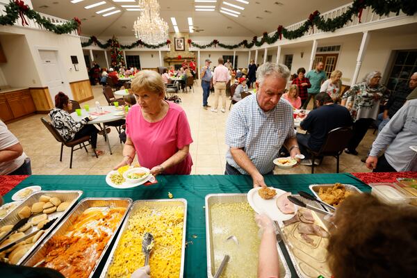 City manager Eddie Wright gets a meal together with his wife, Elaine Wright, during a sit-down Christmas dinner that's free to the community's 204 residents.
 Miguel Martinez / miguel.martinezjimenez@ajc.com