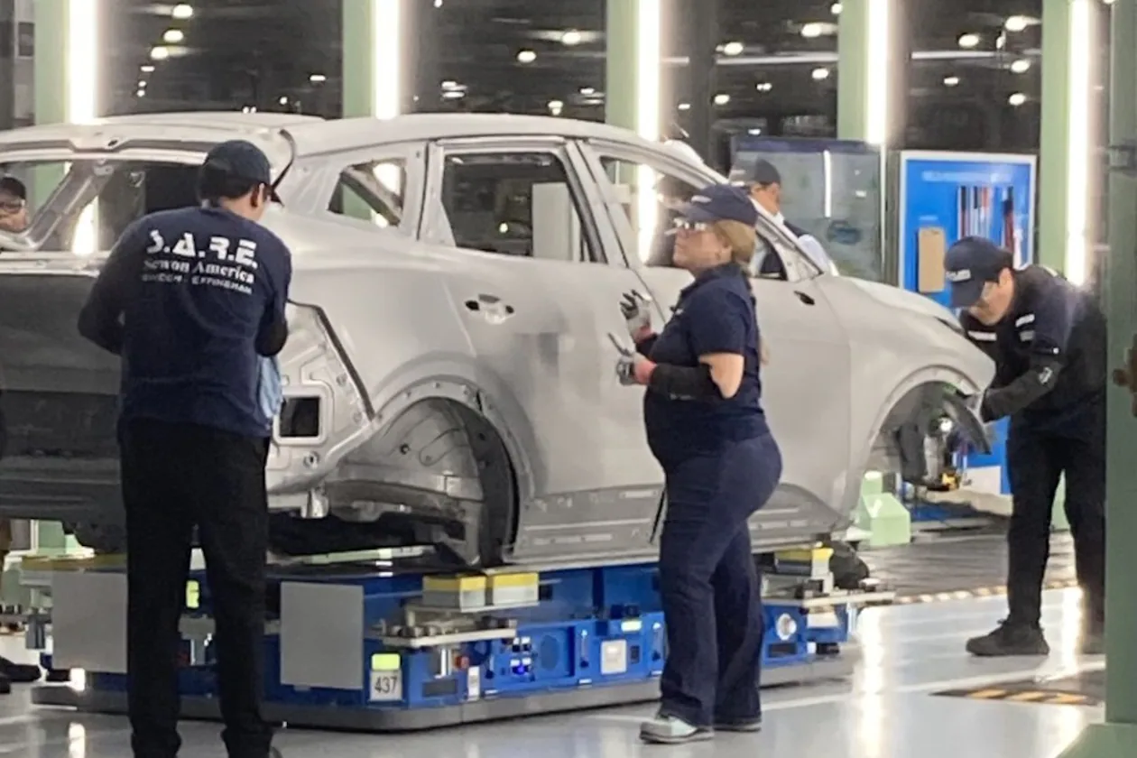 Hyundai factory workers, known as metapros, inspect a Kia Sportage hybrid autobody during the manufacturing process on Tuesday, June 2, 2026, at the Hyundai Metaplant near Savannah, Georgia. (Adam Van Brimmer/AJC)