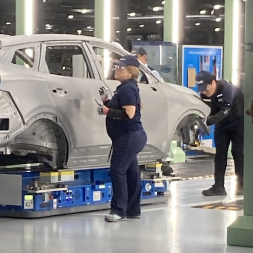Hyundai factory workers, known as metapros, inspect a Kia Sportage hybrid autobody during the manufacturing process on Tuesday, June 2, 2026, at the Hyundai Metaplant near Savannah, Georgia. (Adam Van Brimmer/AJC)