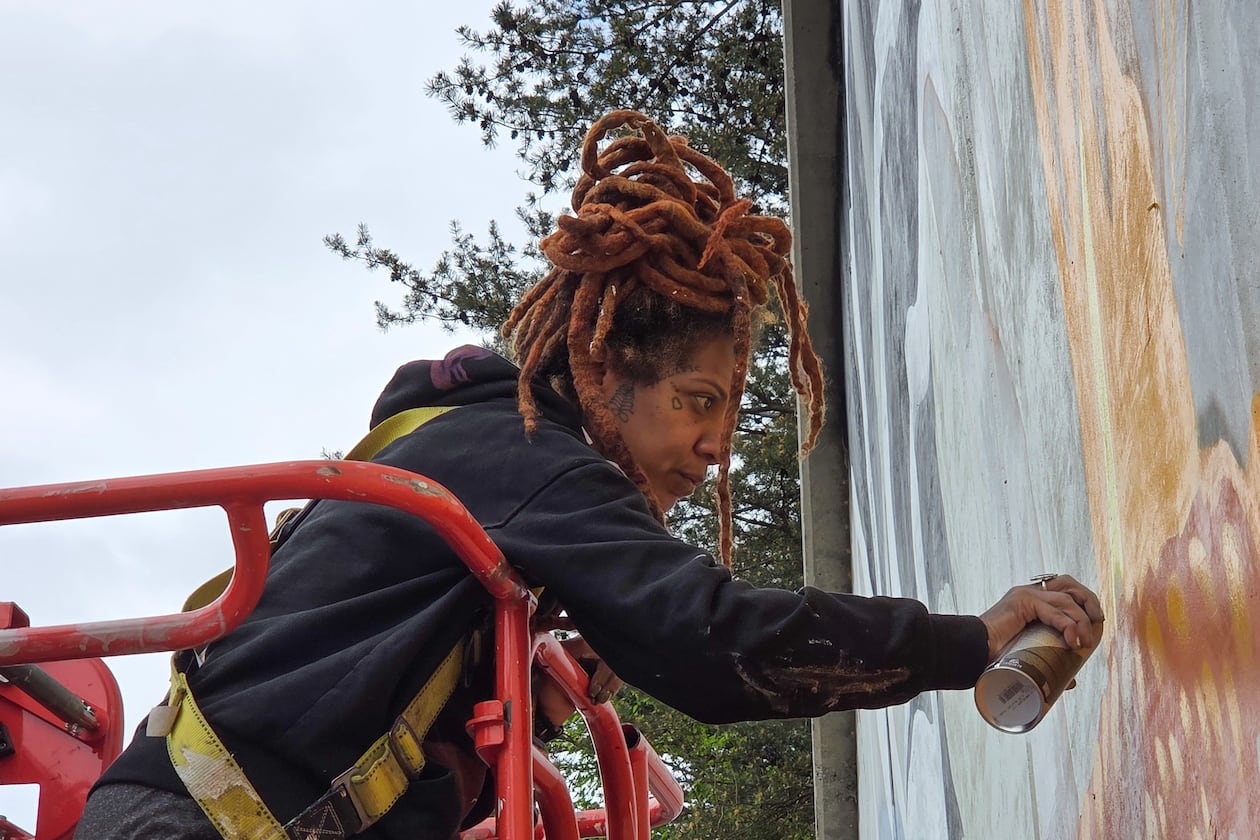 Artist Charity Hamidullah readies her mural "Wild Seed, Wild Flower" in preparation for the World Cup. (Courtesy of Arthur Rudick)