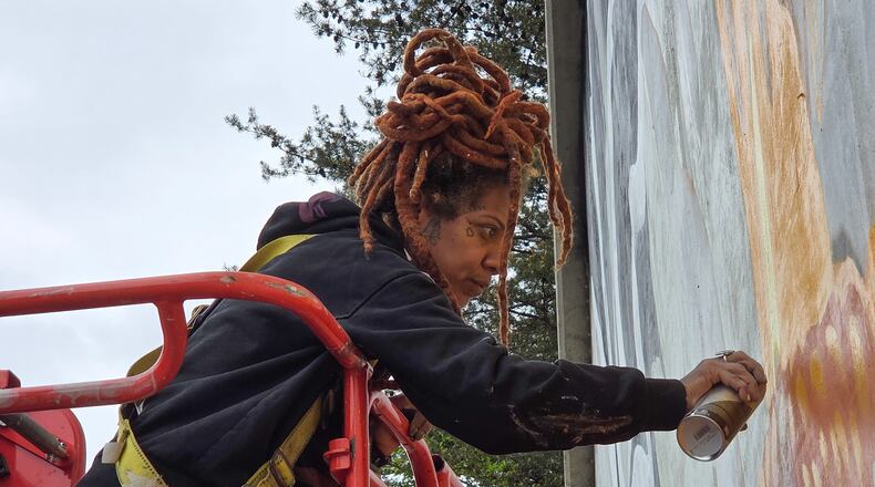 Artist Charity Hamidullah readies her mural "Wild Seed, Wild Flower" in preparation for the World Cup. (Courtesy of Arthur Rudick)