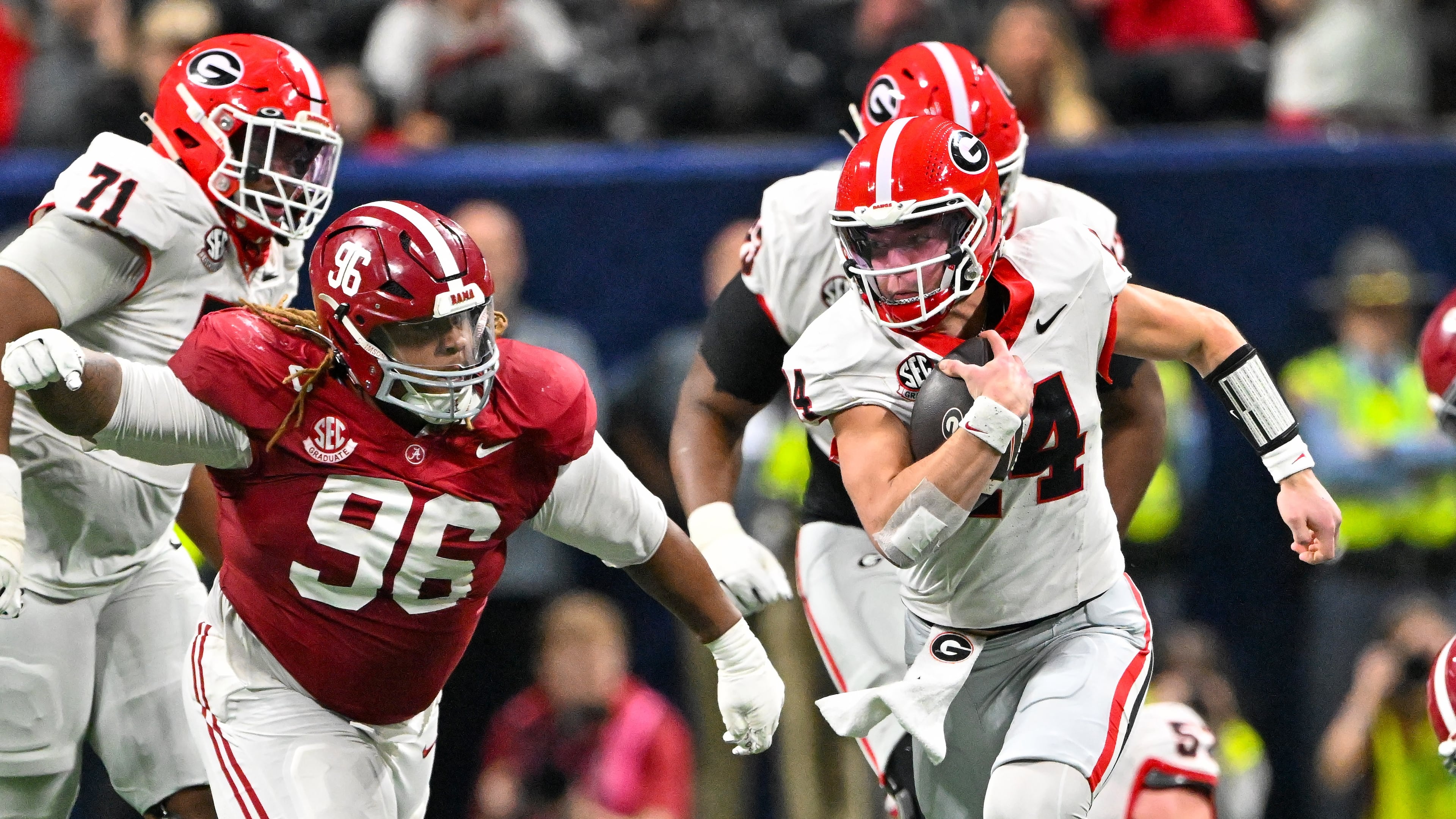Georgia quarterback Gunner Stockton runs a keeper play against Alabama defensive lineman Tim Keenan III during the third quarter of the SEC championship game on Saturday. (Hyosub Shin/AJC)