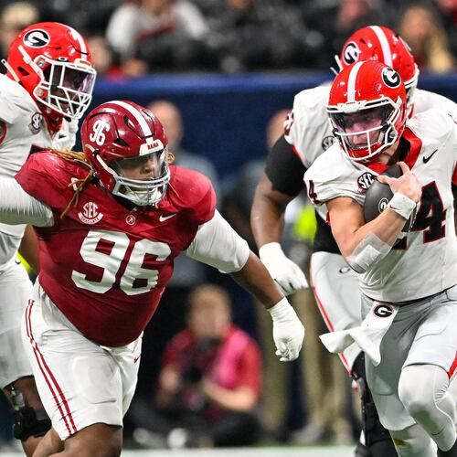 Georgia quarterback Gunner Stockton runs a keeper play against Alabama defensive lineman Tim Keenan III during the third quarter of the SEC championship game on Saturday. (Hyosub Shin/AJC)