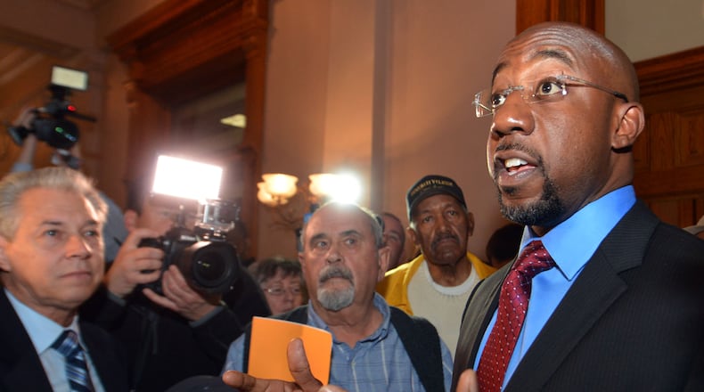 MARCH 18, 2014 ATLANTA Rev Raphael Warnock, pastor of Ebenezer Baptist Church, gives remarks before staging a sit in with other protestors in front of the Governor's office Tuesday. Protesters with Moral Monday hold a rally in the Georgia Capitol rotunda Tuesday, March 18, 2014. Moral Monday Georgia protestors plan to end the legislative session with a protests over the course of Tuesday, starting in the Senate gallery as the chamber's day gets going in the morning and carrying through the afternoon. KENT D. JOHNSON / KDJOHNSON@AJC.COM Rep. Raphael Warnock at the state Capitol in March. Kent D. Johnson, kdjohnson@ajc.com