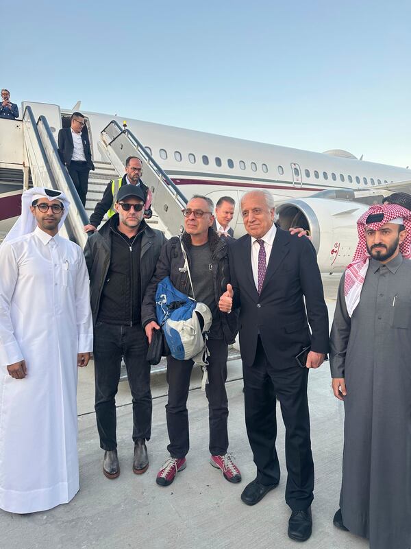In this handout photo released by Qatar Ministry of Foreign Affairs, George Glezmann, center, poses with Qatari diplomats Adam Boehler, second left, and Zalmay Khalilzad, second right, in Kabul, Afghanistan, Thursday, March 20, 2025, before departing to Doha. (Qatar Ministry of Foreign Affairs via AP)