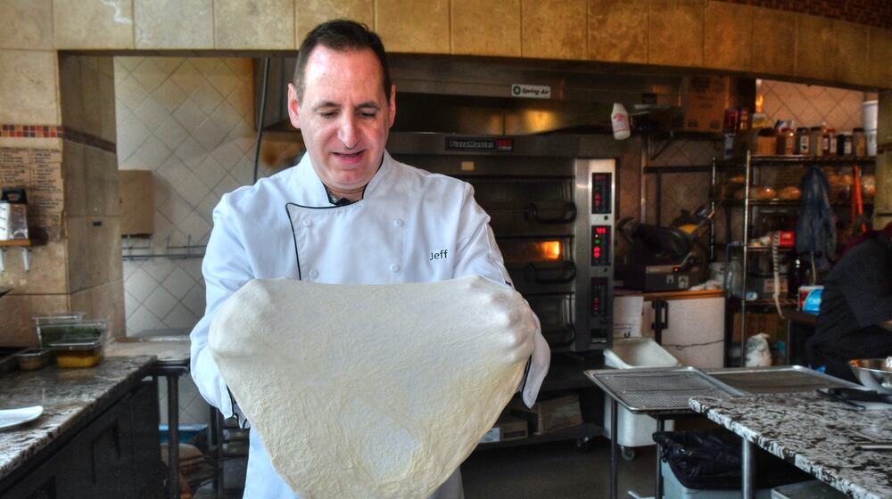 Jeff Varasano stretches the dough for a Margherita pizza. He never tosses the dough, as it makes it tough. Chris Hunt for The Atlanta Journal-Constitution