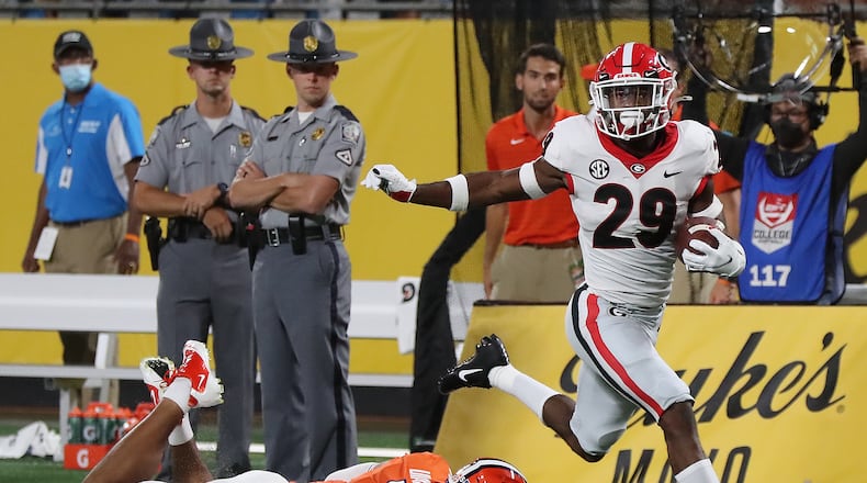 Clemson quarterback D.J. Uiagalelei is the last person to attempt a tackle as Georgia defensive back Christopher Smith intercepts a pass intended for Clemson wide reciever Justyn Ross and returns it for a touchdown and a 7-0 lead during the second quarter in a NCAA college football game on Saturday, Sept 4, 2021, in Charlotte. “Curtis Compton / Curtis.Compton@ajc.com”