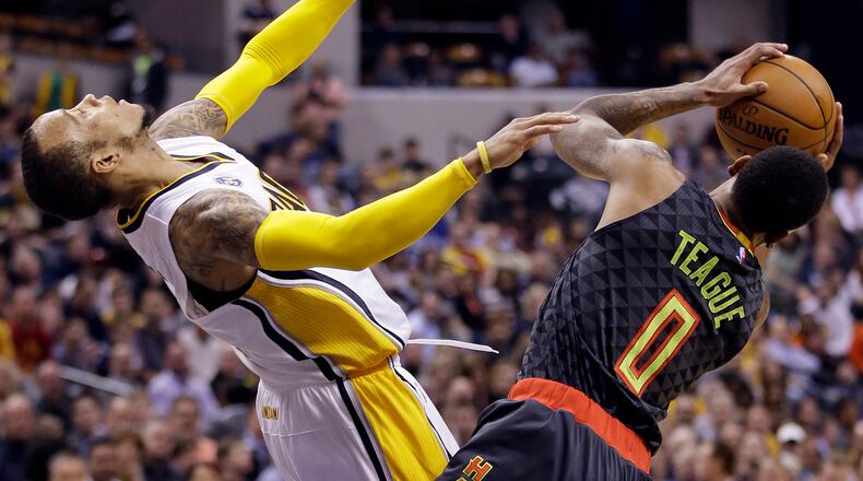 Atlanta Hawks' Jeff Teague (0) is called for a charging foul against Indiana Pacers' Monta Ellis, left, during the second half of an NBA basketball game Thursday, Jan. 28, 2016, in Indianapolis. Indiana won 111-92. (AP Photo/Darron Cummings)