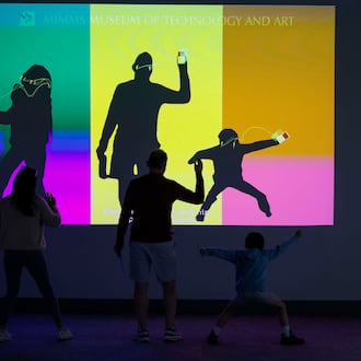 A family plays with an interactive iPod screen at the "50 Years of Innovation from Apple" exhibit at the Mimms Museum in Roswell on Sunday, April 19, 2026.
(Miguel Martinez/AJC)