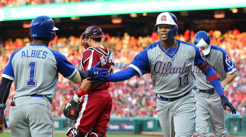 Ronald Acuna Jr. #13 of the Atlanta Braves is congratulated by Ozzie Albies #1 after he hit a two-run home run against the Philadelphia Phillies during the second inning of a baseball game at Citizens Bank Park on July 27, 2019 in Philadelphia, Pennsylvania. (Photo by Rich Schultz/Getty Images)