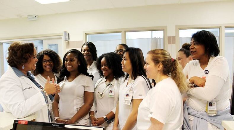 Dr. Jacqueline Herd, chief nursing officer at Grady Memorial Hospital, holds an informal briefing with nurses in the hospital’s intensive care unit.