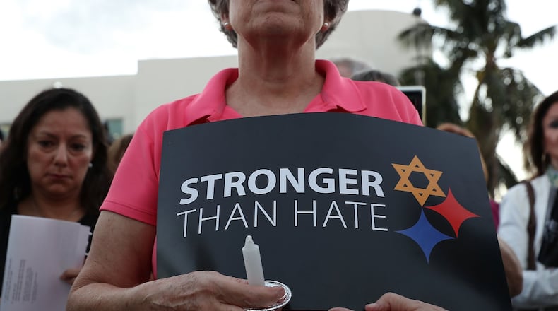 MIAMI BEACH, FL - OCTOBER 30: A person holds a sign as she joins with others for a community-wide Solidarity Vigil at the Holocaust Memorial Miami Beach to remember the victims of the mass shooting at a Pittsburgh synagogue on October 30, 2018 in Miami Beach, Florida. Eleven people were killed in an attack at the Tree of Life Congregation in Pittsburgh’s Squirrel Hill neighborhood on Oct. 27. (Photo by Joe Raedle/Getty Images)