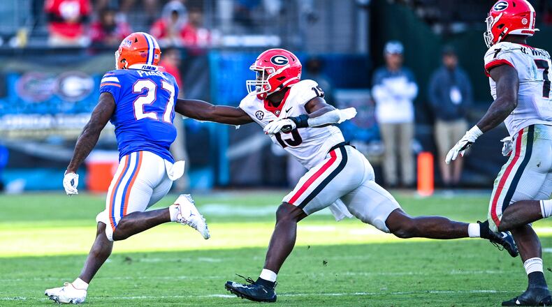 Georgia outside linebacker Adam Anderson (19) reaches for Florida running back Dameon Pierce during the Bulldogs' game the Gators at  TIAA Bank Field in Jacksonville, Fla., on Saturday, Oct. 30, 2021. (Photo by Rob Davis/UGA Athletics)