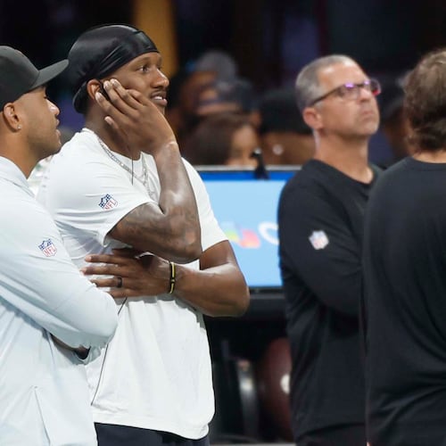 Atlanta Falcons quarterbacks Tua Tagovailoa (left) and Michael Penix Jr. watch from the sidelines Sunday. One of them might start Thursday night's game against the Green Bay Packers. (Miguel Martinez/AJC)