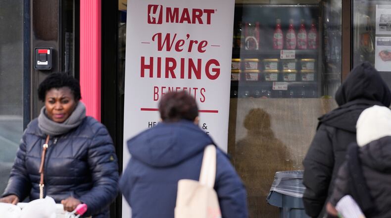 Hiring sign is displayed at a grocery store, in Glenview, Ill., Monday, Dec. 15, 2025. (AP Photo/Nam Y. Huh)