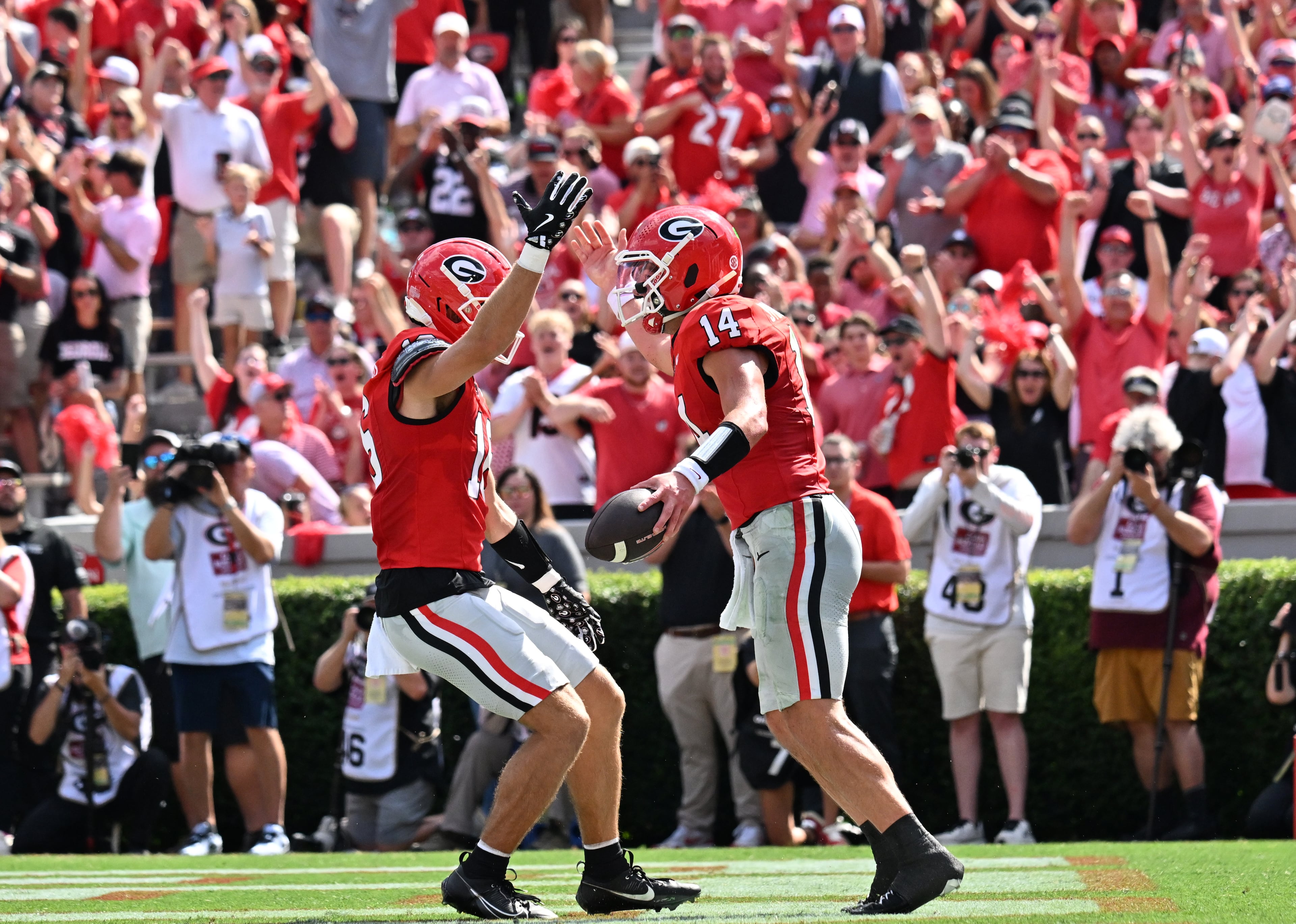 Georgia quarterback Gunner Stockton (14) celebrates with teammates after scoring a touchdown during the first half in an NCAA football game at Sanford Stadium, Saturday, August 30, 2025, in Athens. (Hyosub Shin / AJC)
