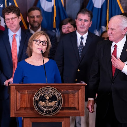 Newly appointed U.S. interim Senator, Darline Graham Nordone, with South Carolina Gov. Henry McMaster, right, speaks to members of the press after being appointed of to fill the vacancy created by the passing of her brother, U.S. Senator Lindsey Graham, at the statehouse Monday, July 13, 2026, in Columbia, S.C. (AP Photo/Sean Rayford)
