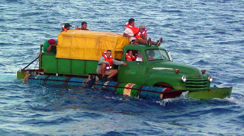 In this U.S. Coast Guard handout, Cuban migrants trying to reach the U.S. coast in Florida ride a makeshift boat made out of a 1951 Chevrolet truck with a propeller driven off the drive shaft July 16, 2003 off the coast of Florida. The U.S. Coast Guard Cutter Key Largo returned the12 Cuban migrants from the vessel back to Cuba after making it within 40 miles of Key West, Florida. The photograph was released a week after the crew was repatriated.