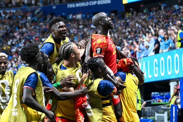 Congo forward Yoane Wissa (top center, in red) and teammates celebrate a 3-1 win over Uzbekistan in a World Cup match at Atlanta Stadium on Saturday, June 27, 2026. (Hyosub Shin/AJC)