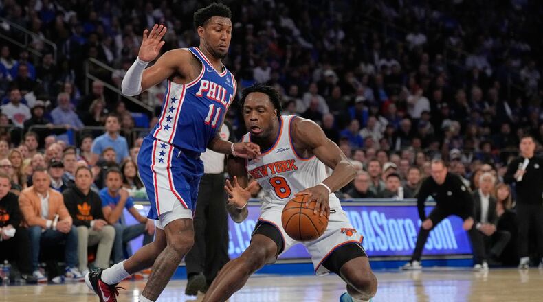 New York Knicks' Og Anunoby, right, drives past Philadelphia 76ers' Justin Edwards during the first half of Game 1 in a second-round NBA basketball playoffs series Monday, May 4, 2026, in New York. (AP Photo/Seth Wenig)