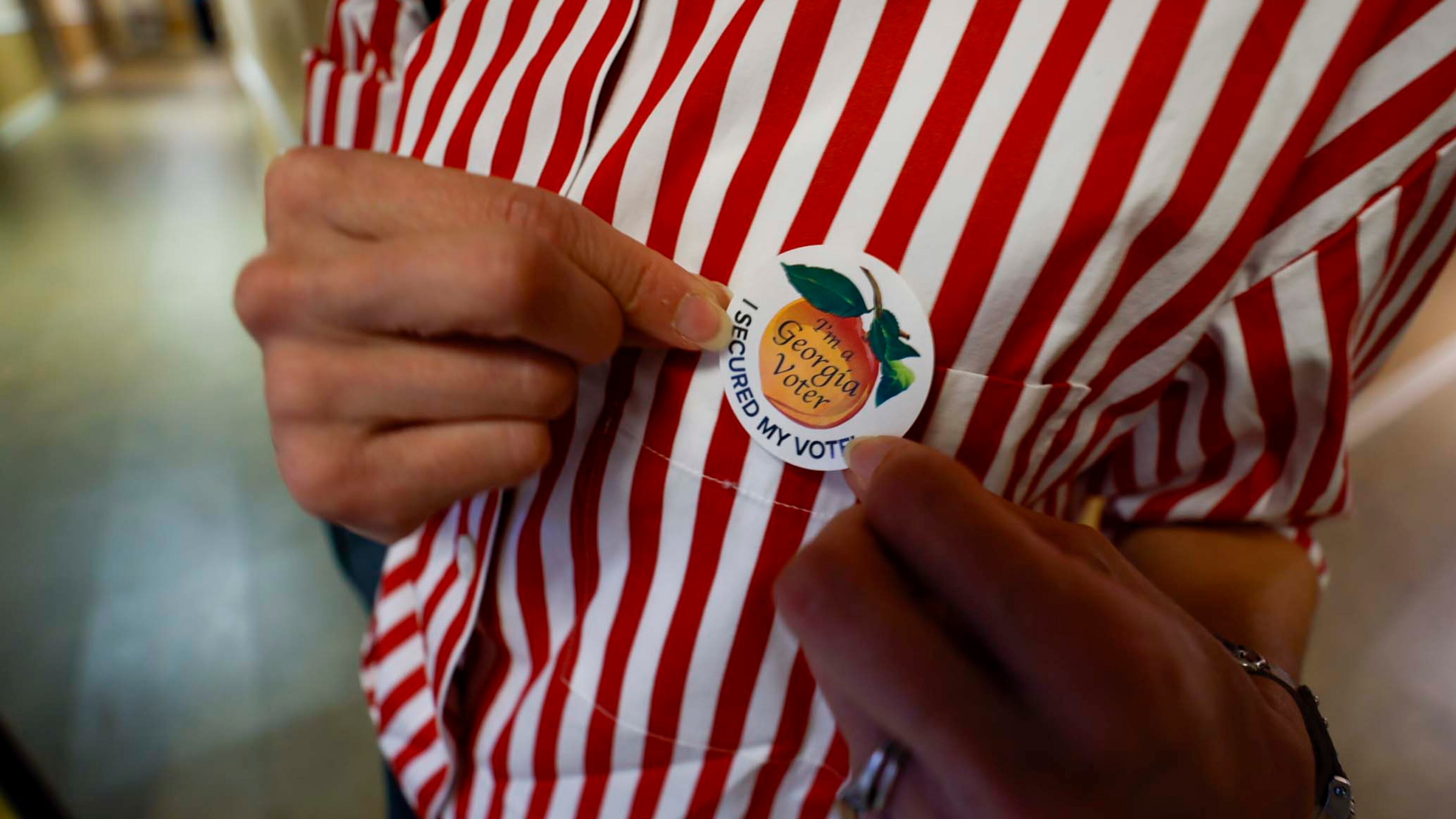 Tamara Lamia puts her voting sticker after casting her ballot at the Israel Baptist Church in Kirkwood during the Georgia Public Service Commission’s special election at Ron Anderson Community Center in Cobb County on Tuesday, June 17, 2025. (Miguel Martinez/AJC)