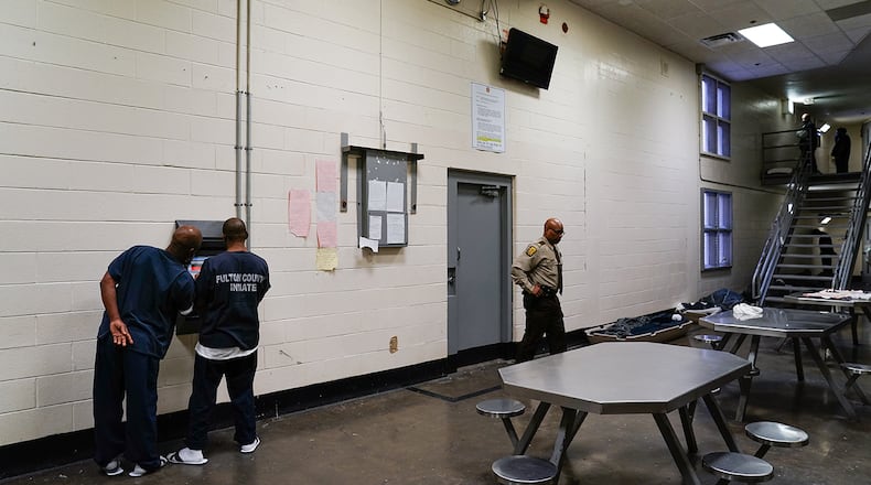 Inmates are seen using a kiosk in their cell block that allows them to schedule visits and medical appointments during a tour of the Fulton County Jail on Monday, December 9, 2019, in Atlanta. (Elijah Nouvelage/Special to the Atlanta Journal-Constitution)