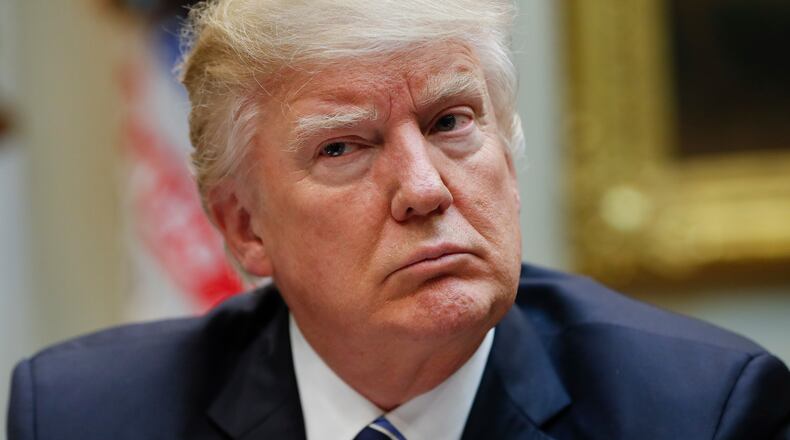 FILE - In this Monday, March 13, 2017 file photo, President Donald Trump listens during a meeting on healthcare in the Roosevelt Room of the White House in Washington. MSNBC's Rachel Maddow host of "The Rachel Maddow Show" was at the center of the political media Tuesday, March 14, 2017, with a story on Trump's tax returns propelled by social media. The White House pushed back even before the release of the documents Tuesday night, saying that publishing the information was illegal. (AP Photo/Pablo Martinez Monsivais, File)
