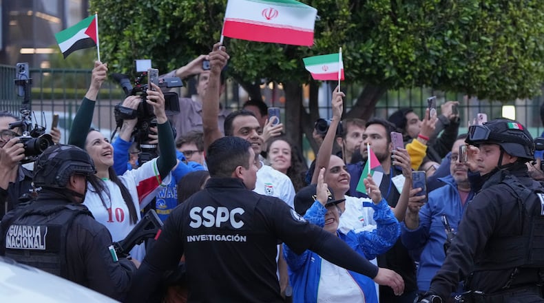 Fans for team Iran wave as players arrive for the World Cup soccer tournament in Tijuana, Mexico, Sunday, June 7, 2026. (AP Photo/Gregory Bull)