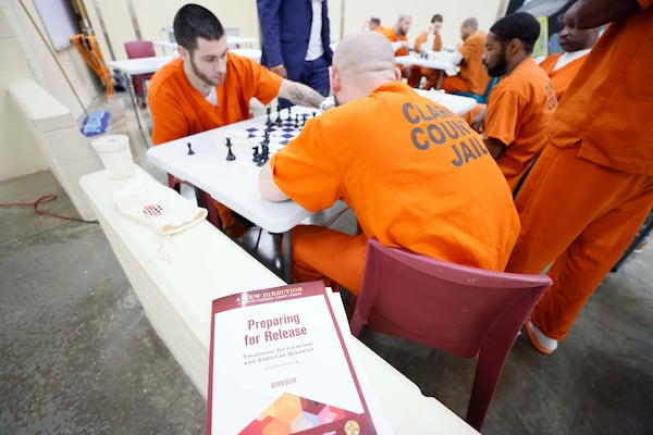 Greg Mouzayck and Kevin Moon are pictured during a chess game at Athens-Clarke County Jail. Some inmates know the game; others have never touched a piece. (Miguel Martinez/AJC)