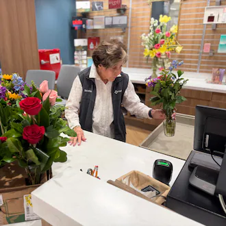 Corky Bowers, a volunteer at Wellstar Kennestone Medical Center, helps customers in the center's gift shop. (Courtesy of Wellstar Health System)