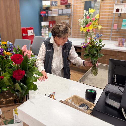 Corky Bowers, a volunteer at Wellstar Kennestone Medical Center, helps customers in the center's gift shop. (Courtesy of Wellstar Health System)