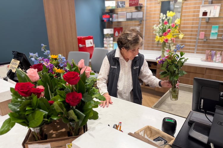 Corky Bowers, a volunteer at Wellstar Kennestone Medical Center, helps customers in the center's gift shop. (Courtesy of Wellstar Health System)