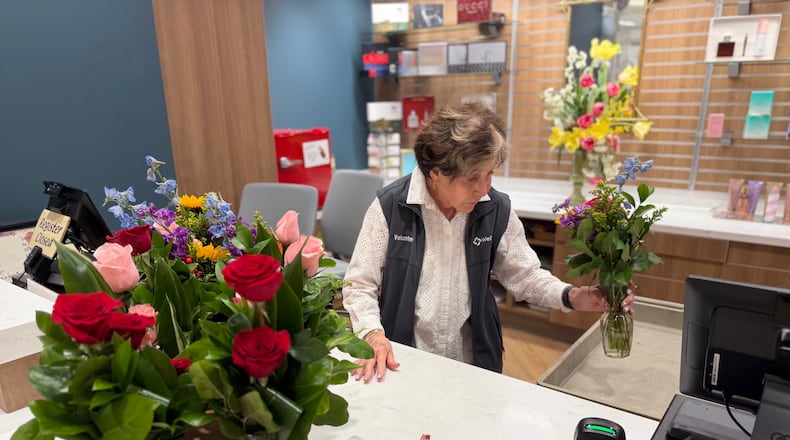 Corky Bowers, a volunteer at Wellstar Kennestone Medical Center, helps customers in the center's gift shop. (Courtesy of Wellstar Health System)
