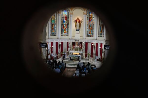 People offer prayers for crew members of the Air India flight that crashed in Ahmedabad last month during a prayer meeting at a church in Mumbai, India, Saturday, July 12, 2025. (AP Photo/ Rafiq Maqbool)