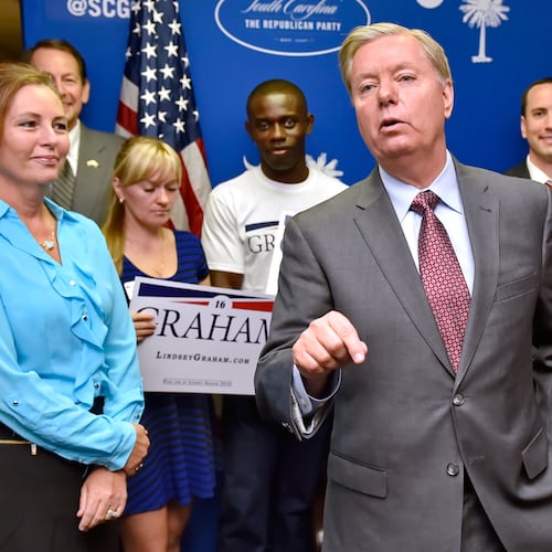 FILE - Republican presidential candidate, Sen. Lindsey Graham, R-S.C., accompanied by his sister Darline, left, speaks at the GOP headquarters in Columbia, S.C., Sept. 1, 2015, where he filed for the South Carolina Presidential Primary. (AP Photo/Richard Shiro, File)