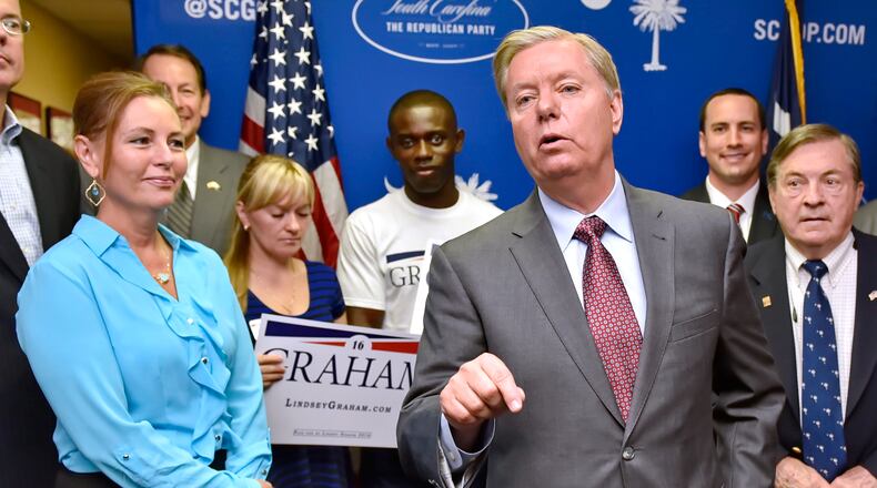FILE - Republican presidential candidate, Sen. Lindsey Graham, R-S.C., accompanied by his sister Darline, left, speaks at the GOP headquarters in Columbia, S.C., Sept. 1, 2015, where he filed for the South Carolina Presidential Primary. (AP Photo/Richard Shiro, File)