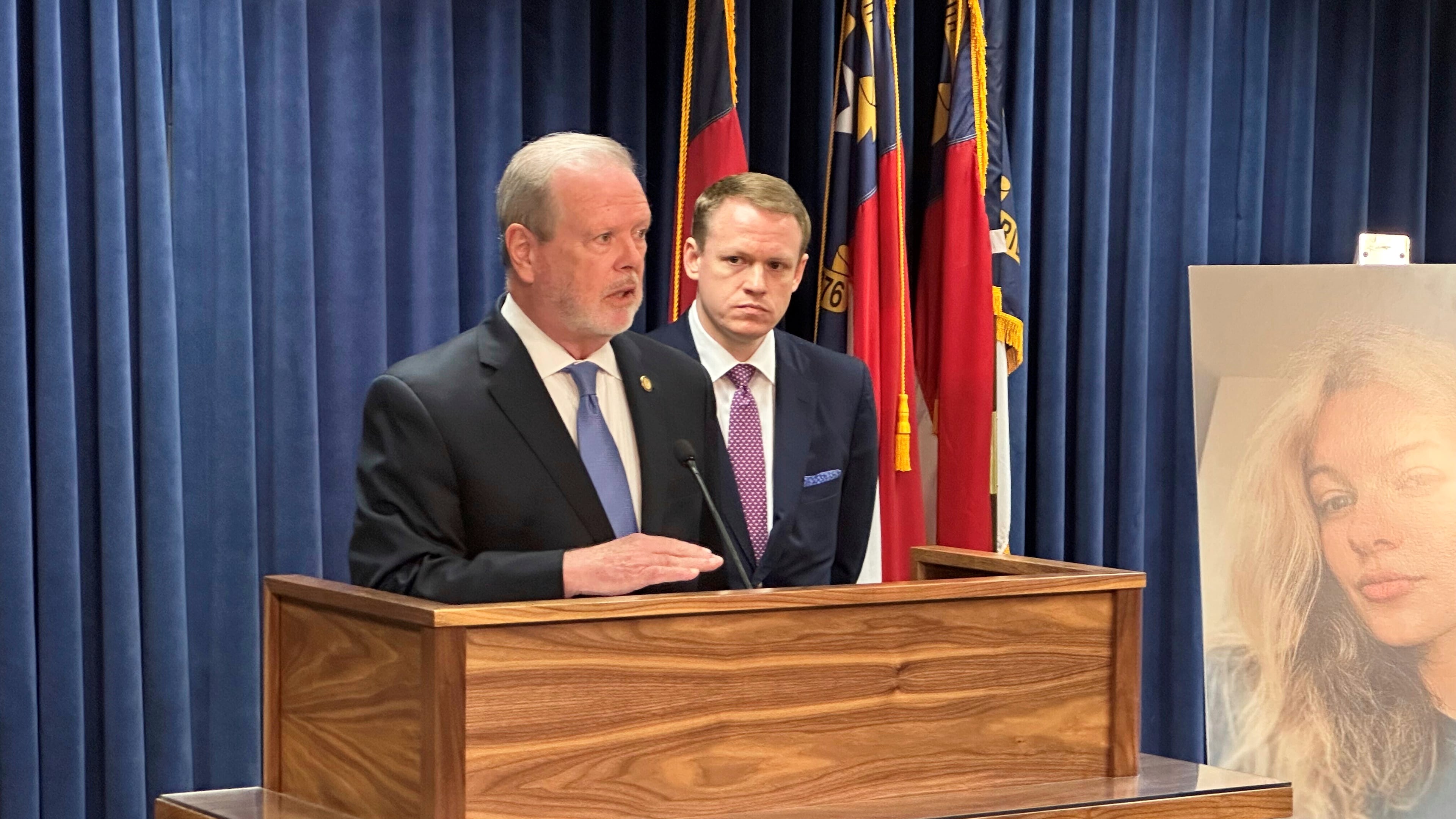 North Carolina state Senate leader Phil Berger, R-Rockingham, left, speaks while House Speaker Destin Hall, R-Caldwell, listens and stands next to a photo of commuter train stabbing victim Iryna Zarutska, during a Legislative Building news conference, in Raleigh, N.C., Thursday, Sept. 11, 2025. (AP Photo/Gary D. Robertson)