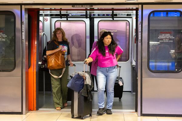 Travelers leave the Plane Train at Hartsfield-Jackson Atlanta International Airport. (Arvin Temkar/AJC 2025)