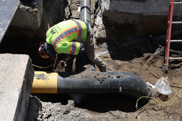 A pipeline worker works on a gas pipeline replacement project in Chicago. The federal government in 2024 granted more than $13 million to small utilities across Georgia to upgrade their gas pipes for safety and to reduce emissions. (TNS)