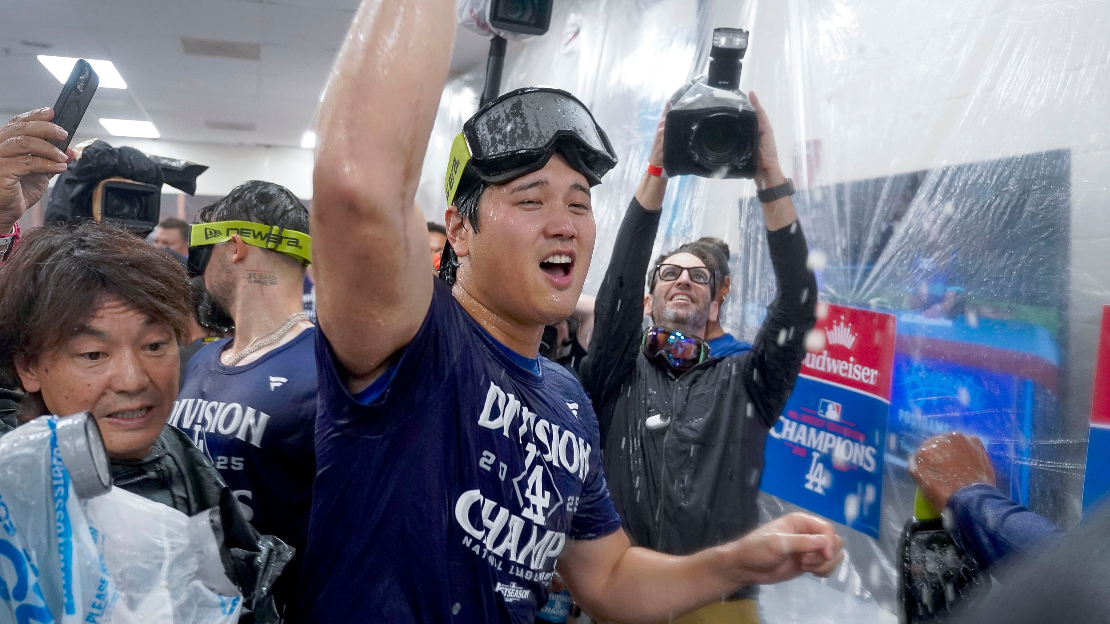Los Angeles Dodgers two-way player Shohei Ohtani (17) center, celebrates after the Dodgers clinched the National League West title against the Arizona Diamondbacks during a baseball game at Chase Field Thursday, Sept. 25, 2025, in Phoenix. (AP Photo/Darryl Webb)