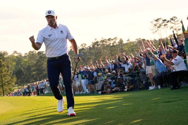Bryson DeChambeau celebrates after a birdie on the 18th hole during the third round at the Masters golf tournament, Saturday, April 12, 2025, in Augusta, Ga. (AP Photo/David J. Phillip)