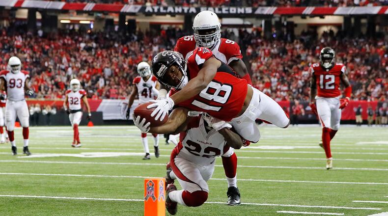 ATLANTA, GA - NOVEMBER 27: Taylor Gabriel #18 of the Atlanta Falcons dives for the pylon past Tony Jefferson #22 of the Arizona Cardinals to score a touchdown during the second half at the Georgia Dome on November 27, 2016 in Atlanta, Georgia. (Photo by Kevin C. Cox/Getty Images)