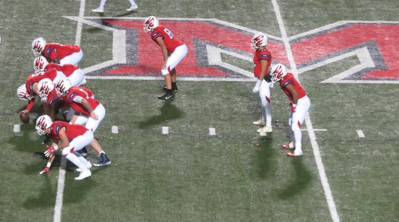 Milton Eagles quarterback Jordan Yates (13) waits for the ball to be snapped during a Round 2 game in Class AAAAAAA state playoffs against the Mill Creek Hawks on Friday, Nov. 16, 2018. (Adam Krohn/special)
