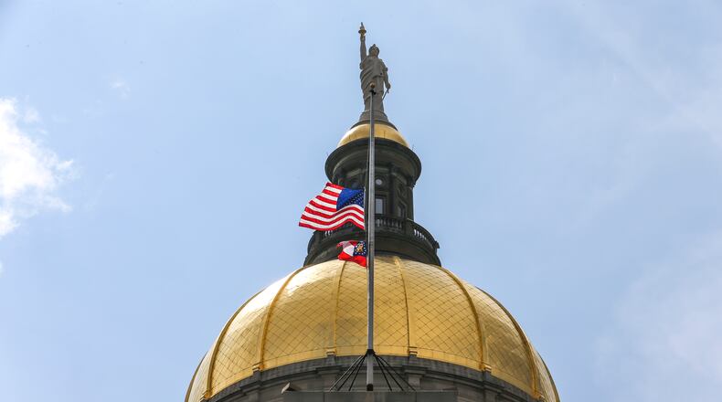 July 11, 2019 Atlanta : The United States and State of Georgia flags flew half-staff at the Georgia State Capitol on Thursday July 11, 2019 after Governor Kemp signed an executive order in memory of Hall County deputy Nicolas Dixon who was shot and killed. JOHN SPINK/JSPINK@AJC.COM