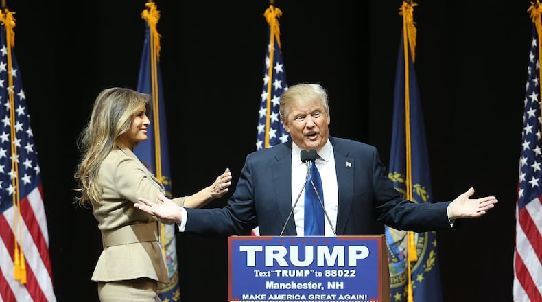 MANCHESTER, NH - FEBRUARY 08: Republican presidential candidate Donald Trump speaks as his wife, Melania Trump, walks near him during a campaign rally at Verizon Wireless Arena on February 8, 2016 in Manchester, New Hampshire. Democratic and Republican Presidential candidates are finishing up with the last full day of campaigning before voters head to the polls tomorrow. (Photo by Joe Raedle/Getty Images)