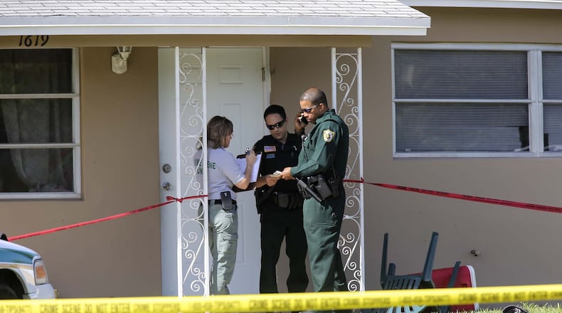 Palm Beach County Sheriff’s Office officials work outside of a home in unincorporated West Palm Beach, where one toddler died and another is still in critical condition after being found Thanksgiving morning in a backyard swimming pool on Kudza Road near Forest Hill Boulevard. (Bruce R. Bennett / The Palm Beach Post)