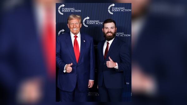 Orien Roy, right, gives a “thumbs up” while posing with former President Donald Trump.