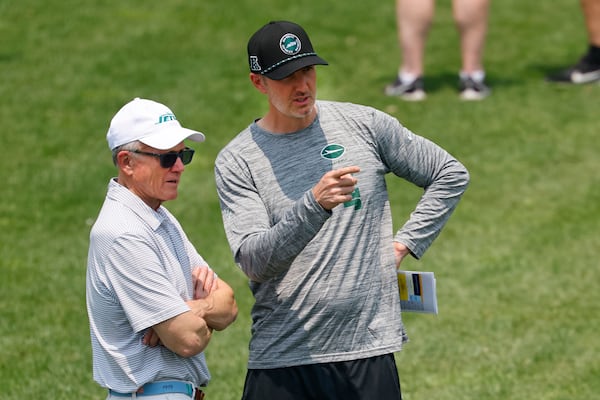 New York Jets owner Woody Johnson, left, and general manager Darren Mougey, right, during practice at NFL football minicamp, Wednesday, June 11, 2025, in Florham Park,N.J. (AP Photo/Noah K. Murray)