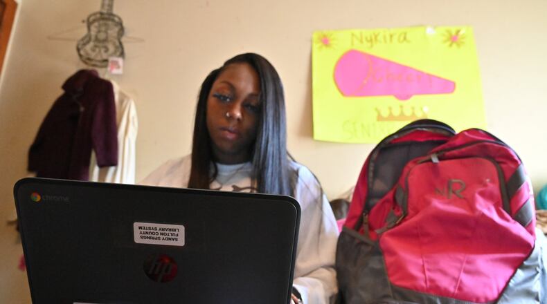 Nykira Ross checks emails using a laptop that she borrowed from Fulton County library after leaving Albany State University in the wake of the COVID-19 outbreak. Hyosub Shin / Hyosub.Shin@ajc.com